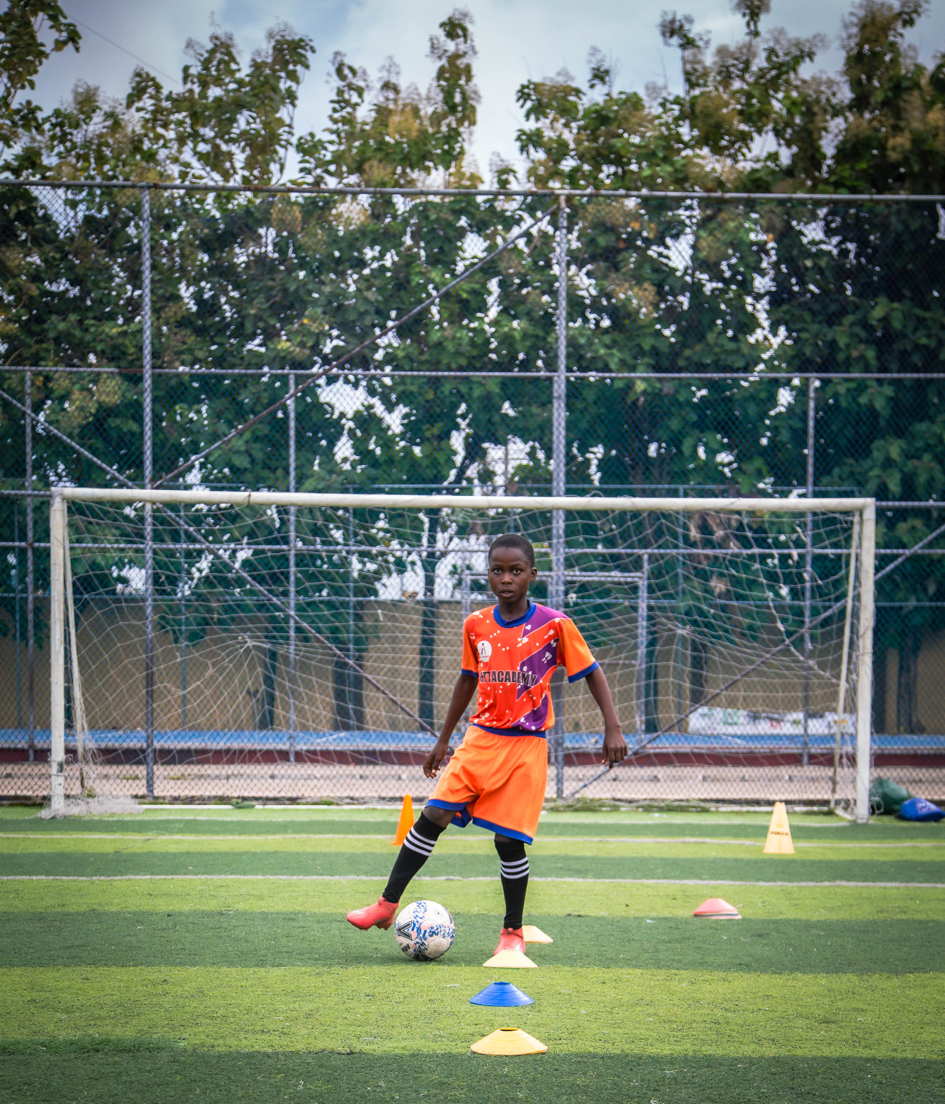 HTT Academy player training with cones near the goal